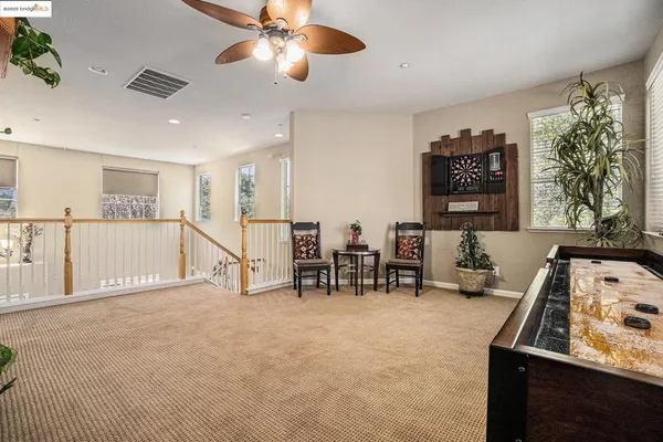 a bedroom with a bed and a large mirror on the dresser