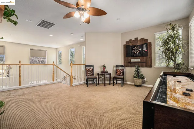 a bedroom with a bed and a large mirror on the dresser