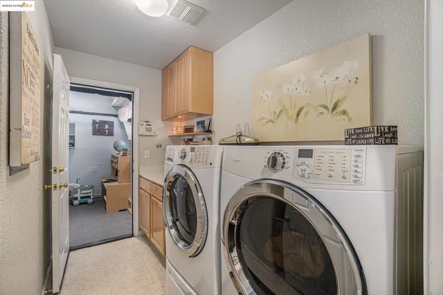 a view of an empty room with closet and cabinet