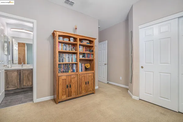 a view of a patio with couches table and chairs with garden and plants