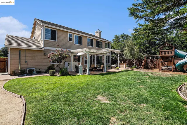 a view of a chairs and fire pit in the patio