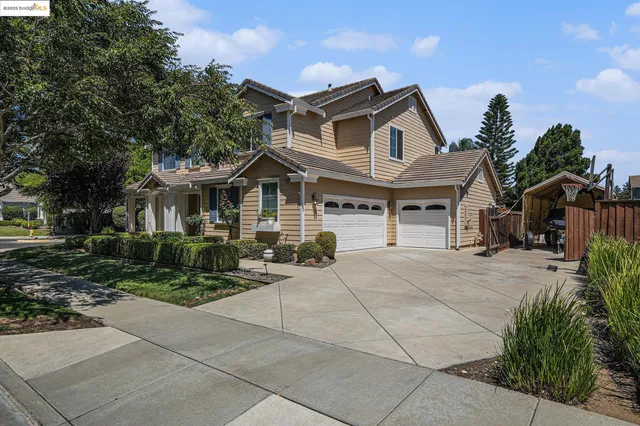a living room with furniture and two large window
