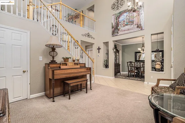 a living room with furniture a large window and a table
