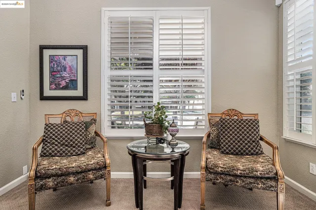 a living room with furniture a fireplace and a large window