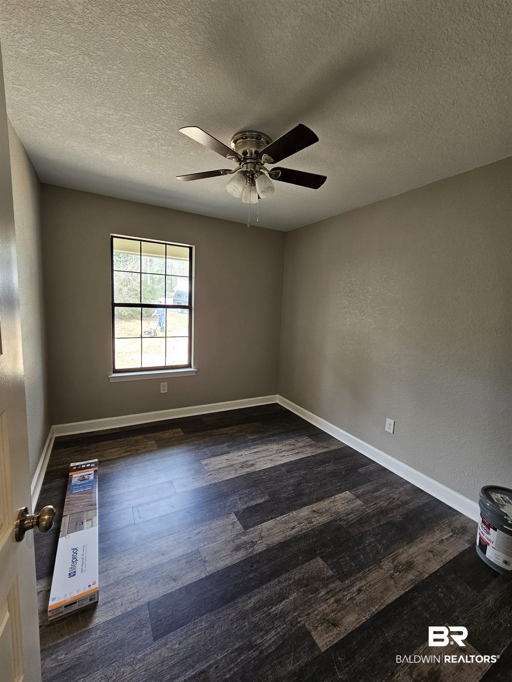 138 Wicker Way Daphne, AL 36526 - Photo 19 of 32 Spare room featuring a textured wall, a textured ceiling, dark wood finished floors, and a ceiling fan