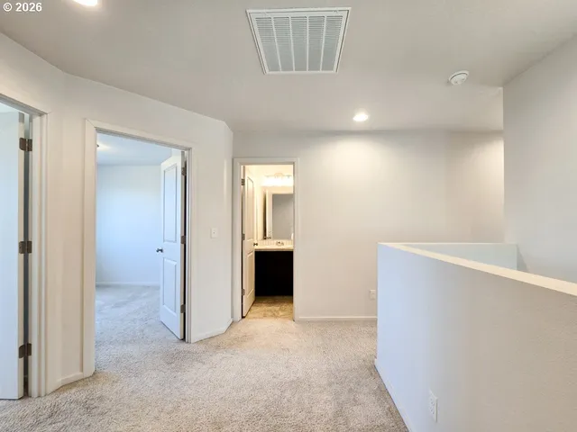 an empty room with windows and cabinet