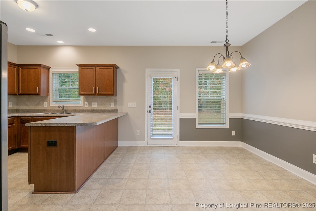 159 English Oak Drive Bunnlevel, NC 28323 - Photo 13 of 48 a kitchen with stainless steel appliances granite countertop a sink and a stove