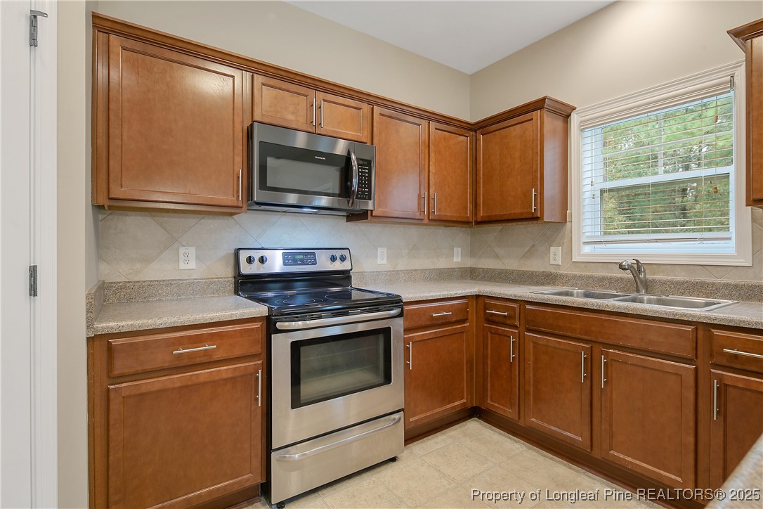 159 English Oak Drive Bunnlevel, NC 28323 - Photo 20 of 48 a kitchen with stainless steel appliances granite countertop white cabinets granite counter tops and a window