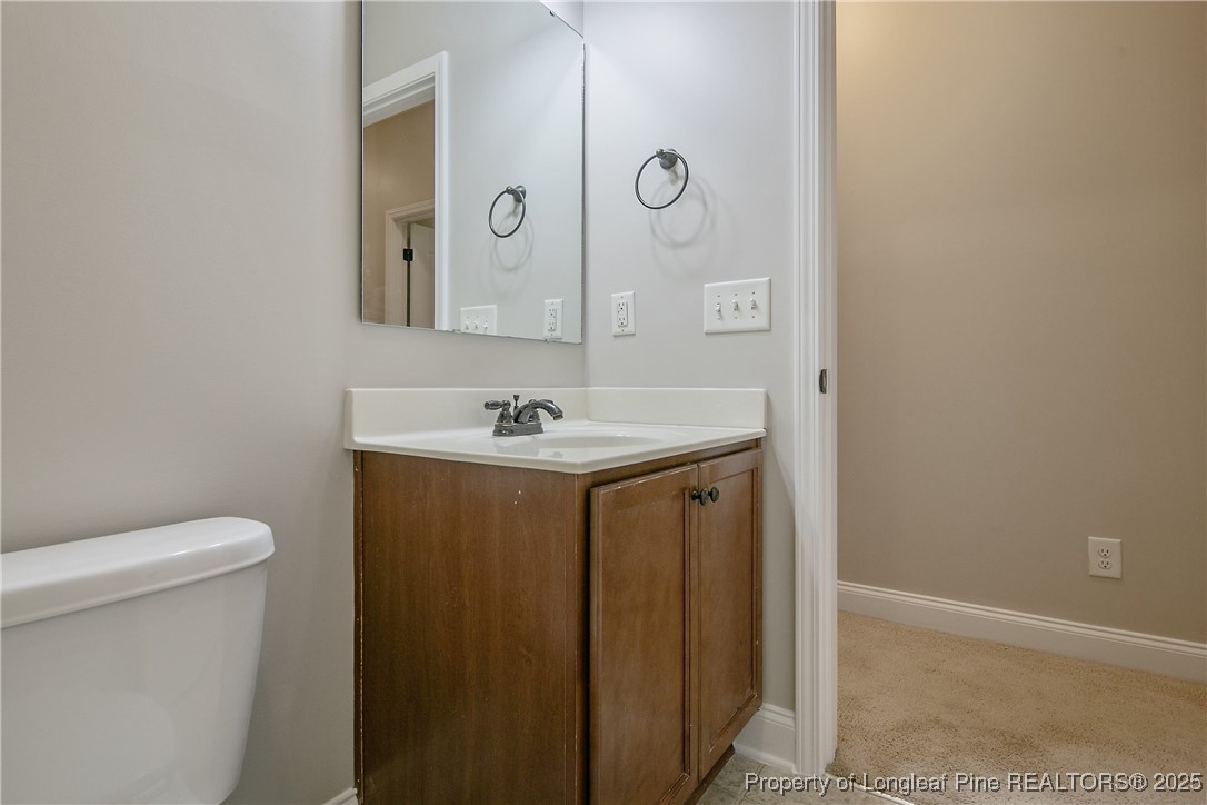159 English Oak Drive Bunnlevel, NC 28323 - Photo 29 of 48 a bathroom with a sink a toilet and mirror