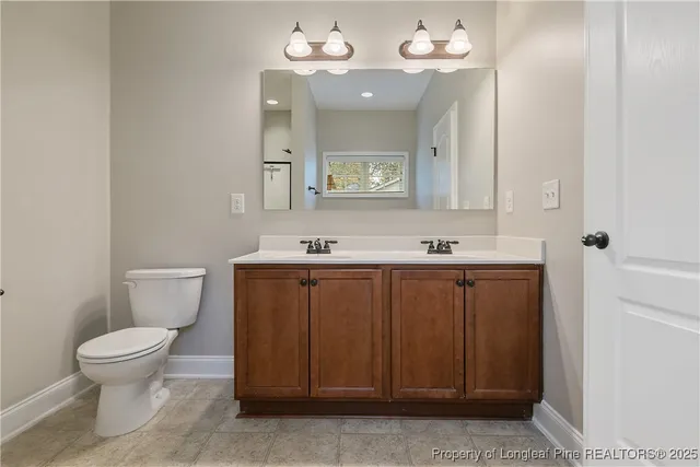 a bathroom with a sink vanity and a mirror