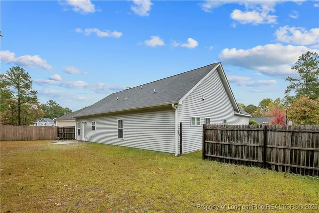 a view of a house with wooden fence