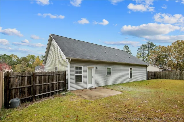 a view of a field with trees in background
