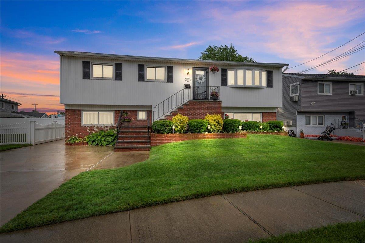 a front view of a house with a yard and outdoor seating