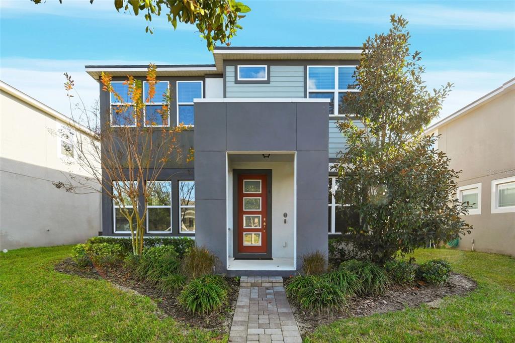 two front view of a house with garden