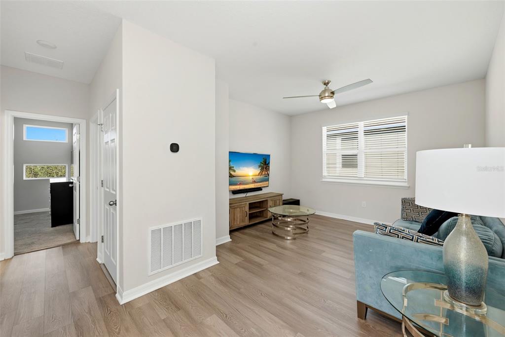 16662 Wingspread Loop Winter Garden, FL 34787 - Photo 13 of 24 a living room with furniture and a flat screen tv