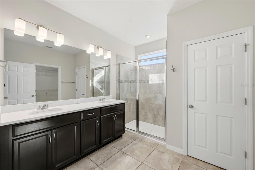 16662 Wingspread Loop Winter Garden, FL 34787 - Photo 15 of 24 a spacious bathroom with a shower sink and mirror