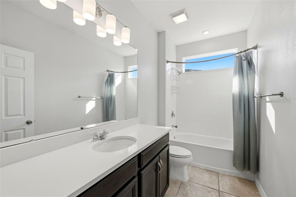 16662 Wingspread Loop Winter Garden, FL 34787 - Photo 17 of 24 a bathroom with a sink a toilet and shower
