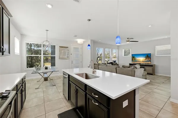 a kitchen with kitchen island a sink counter top space and appliances