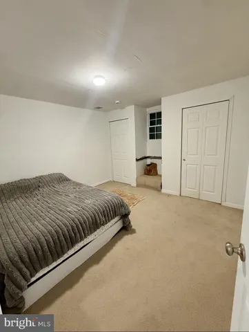 a spacious bedroom with a bed and cabinets