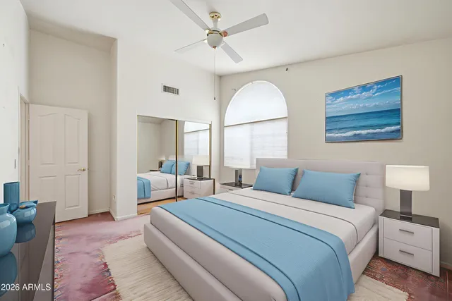 a bedroom with a large bed and a chandelier