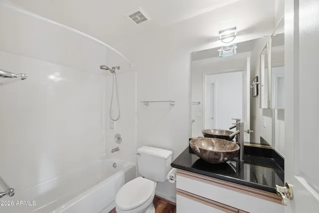 a bathroom with a toilet a sink and bathtub