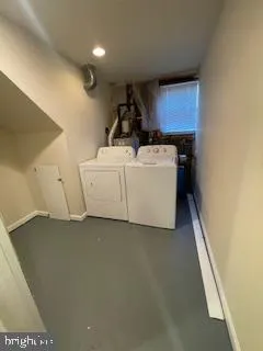 a view of storage and utility room with washer and dryer