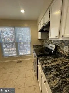 a kitchen with a stove a sink and a microwave