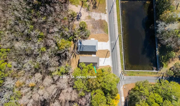 a bed room with a bed and a chandelier
