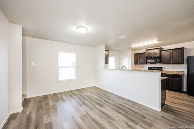 a view of kitchen with sink microwave and stove