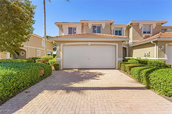 a front view of a house with a yard and garage