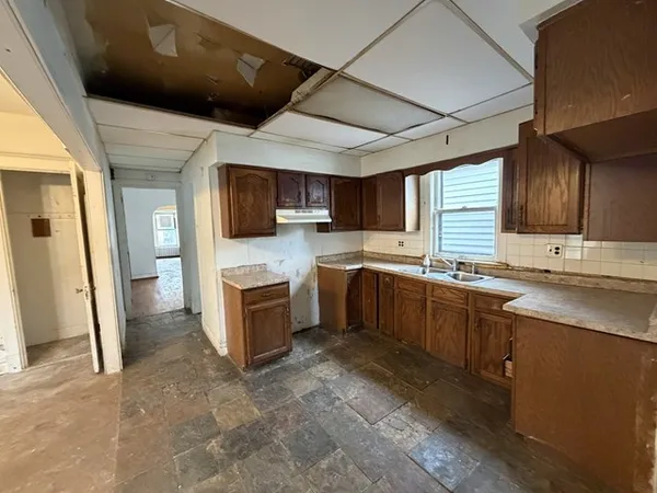 a kitchen with a sink stainless steel appliances and cabinets