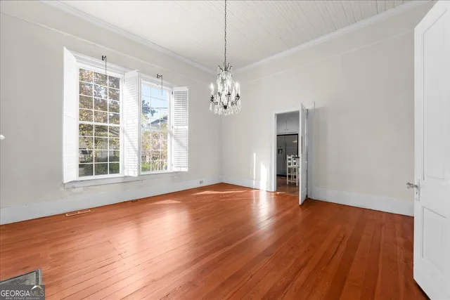 a view of livingroom with window wooden floor and chandelier