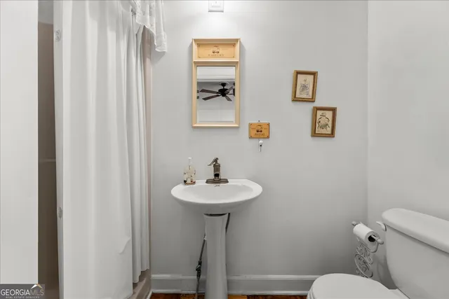 a bathroom with a sink a mirror and a toilet