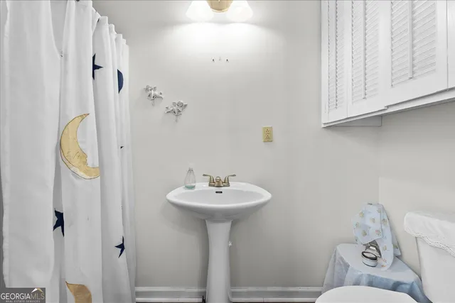 a bathroom with a sink a mirror and a toilet