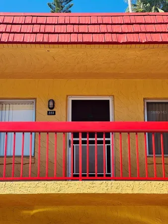 a view of swimming pool with red wall