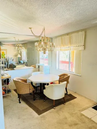 a living room with furniture a table and chairs