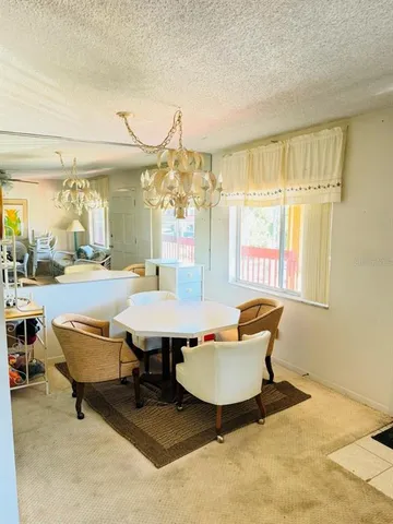 a living room with furniture a table and chairs