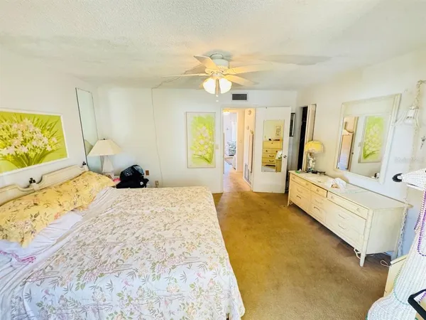 a spacious bedroom with a bed and large windows