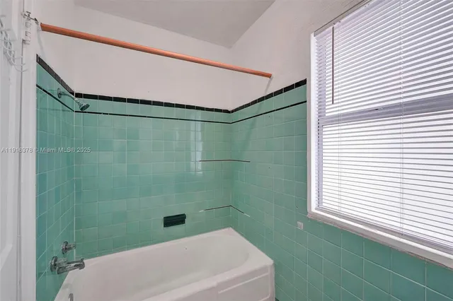 a bathroom with a shower and a sink