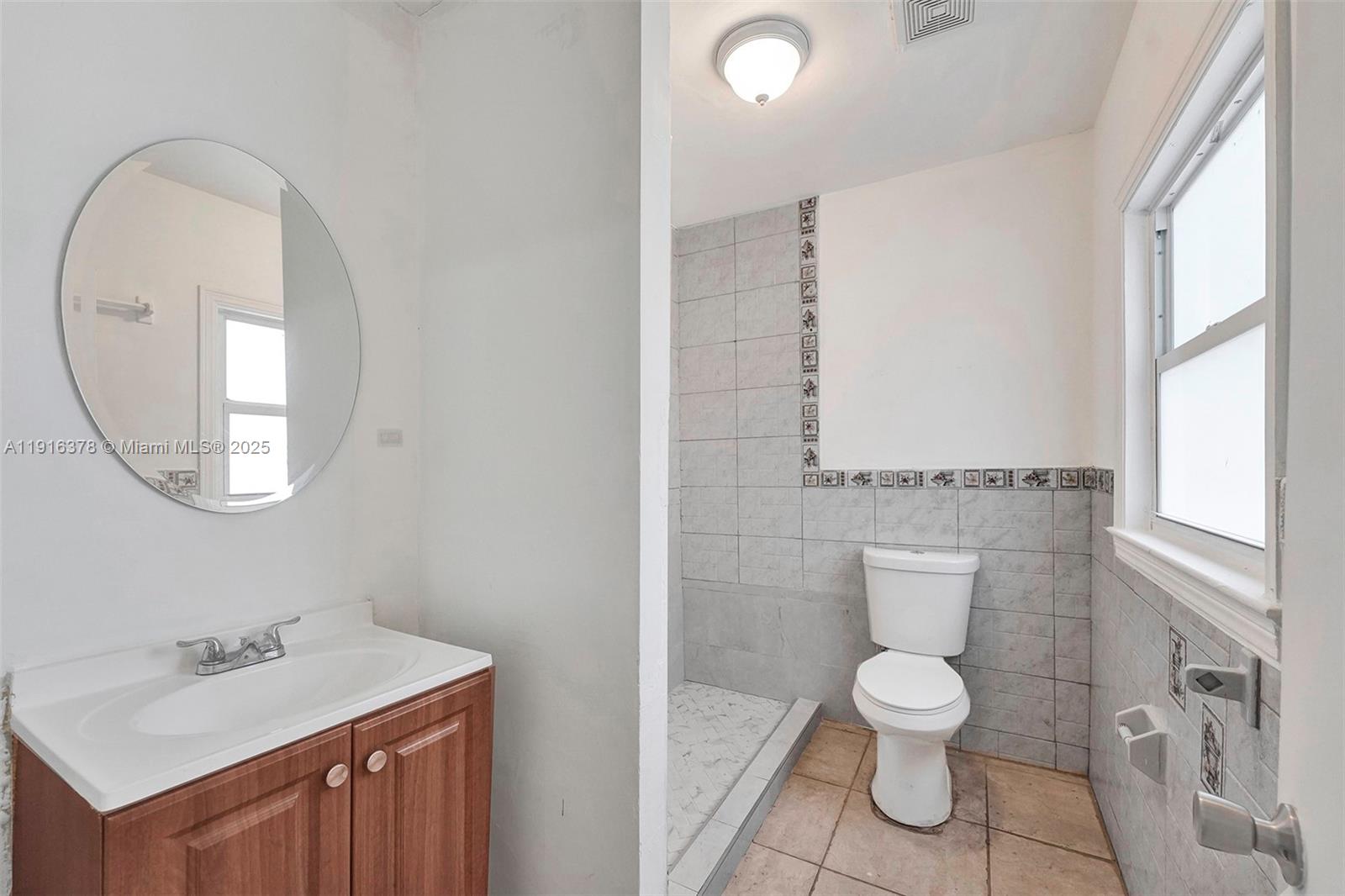 2811 Southwest 3rd Street Miami, FL 33135 - Photo 16 of 40 a white toilet sitting next to a bathroom sink