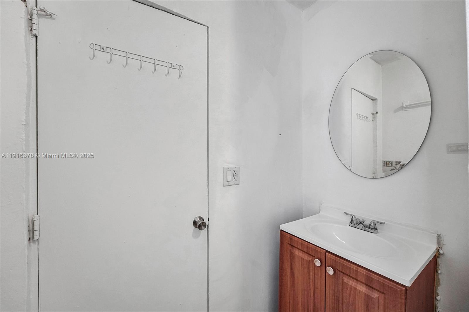 2811 Southwest 3rd Street Miami, FL 33135 - Photo 17 of 40 a bathroom with a sink a mirror and a toilet