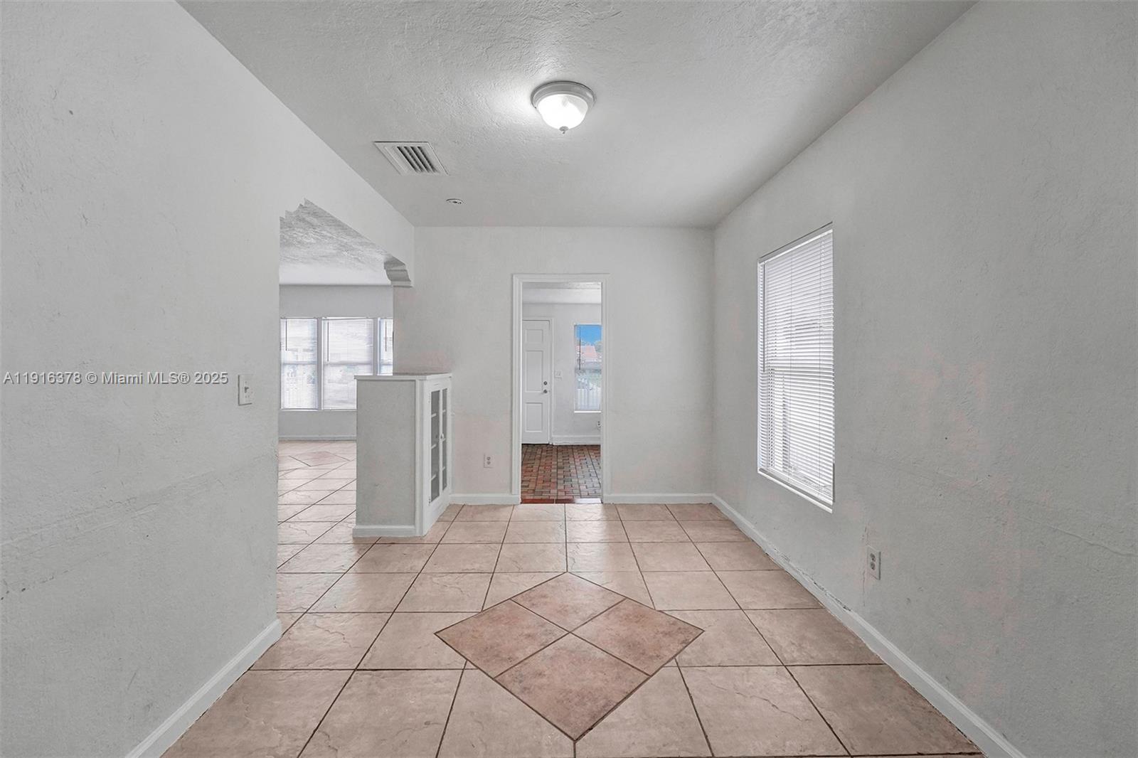 2811 Southwest 3rd Street Miami, FL 33135 - Photo 28 of 40 a view of an empty room with window and wooden floor