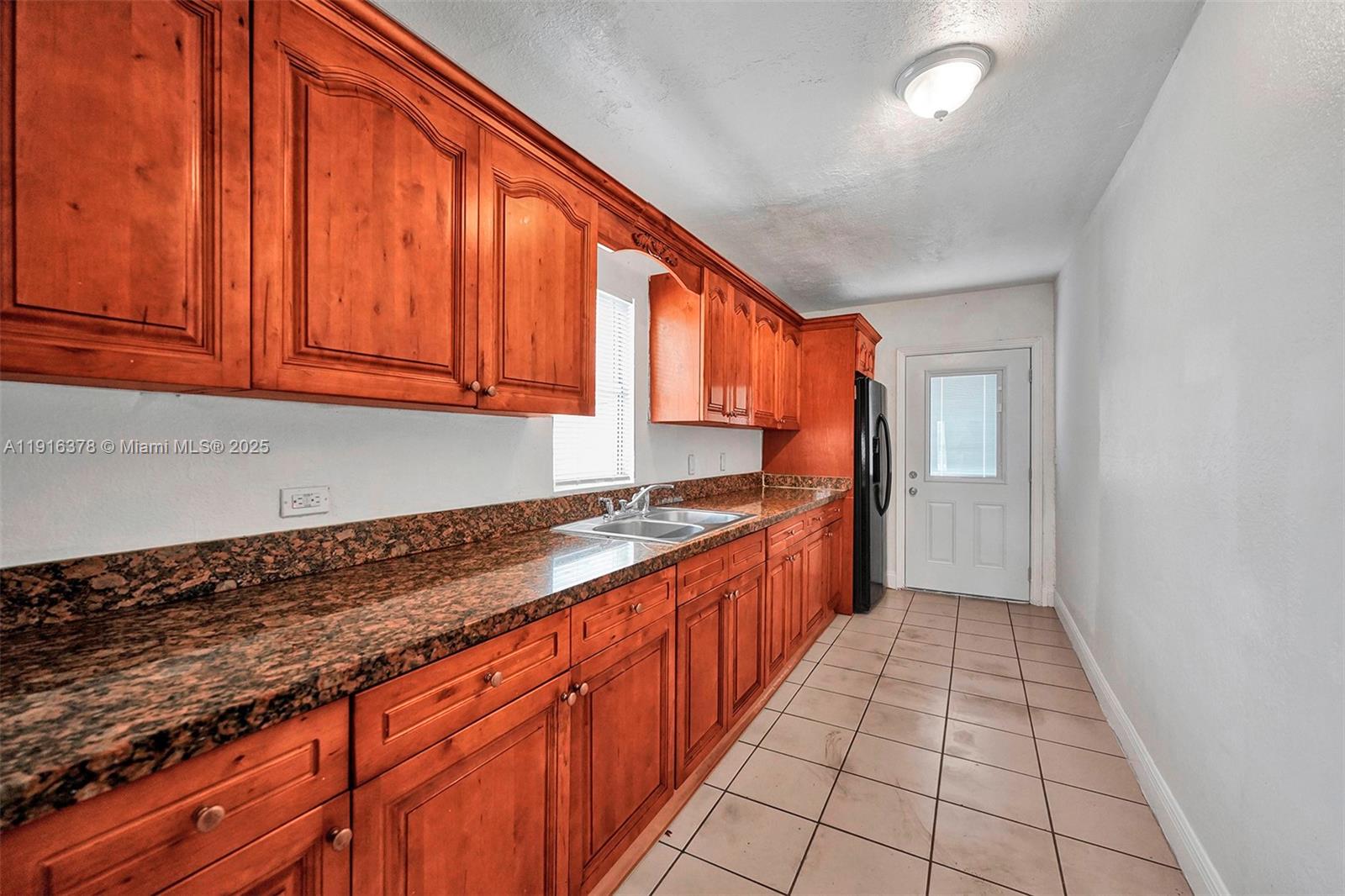 2811 Southwest 3rd Street Miami, FL 33135 - Photo 29 of 40 a large kitchen with stainless steel appliances granite countertop a sink stove and cabinets