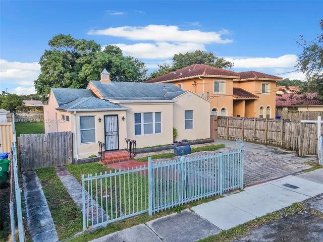 a front view of house with deck and yard