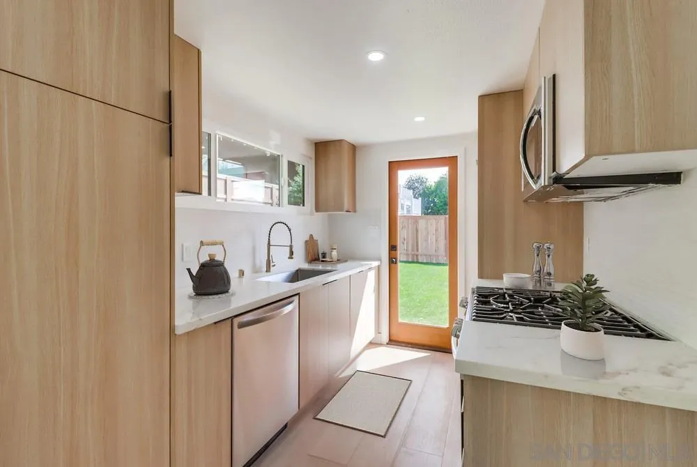 923 Melba Road Encinitas, CA 92024 - Photo 23 of 28 a kitchen with a sink and a stove top oven