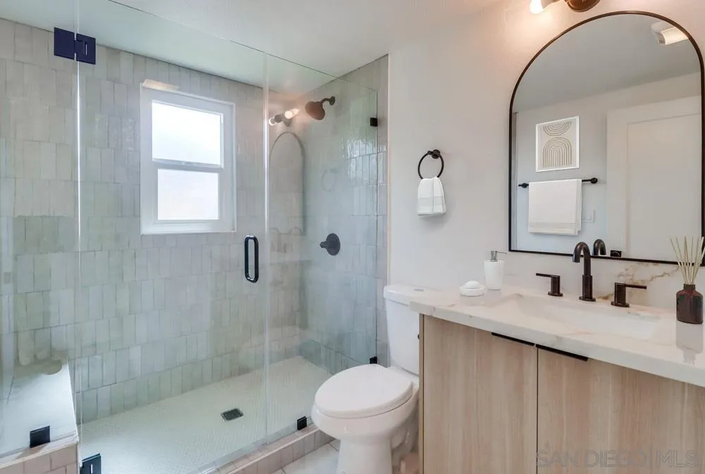 923 Melba Road Encinitas, CA 92024 - Photo 24 of 28 a bathroom with a sink toilet and shower