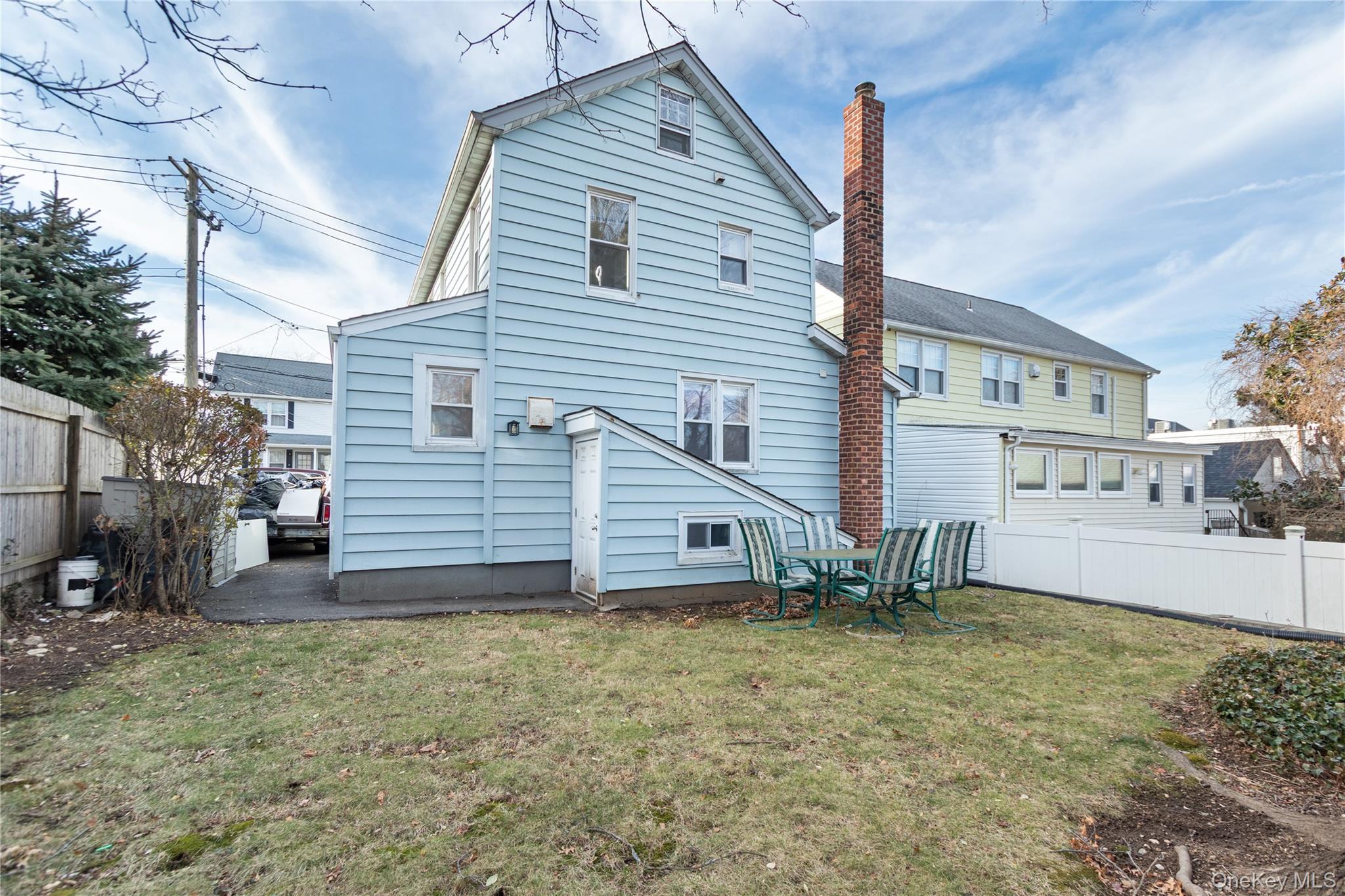 57 Spring Street, Unit 1 Oyster Bay, NY 11771 - Photo 11 of 11 a view of a house with a yard