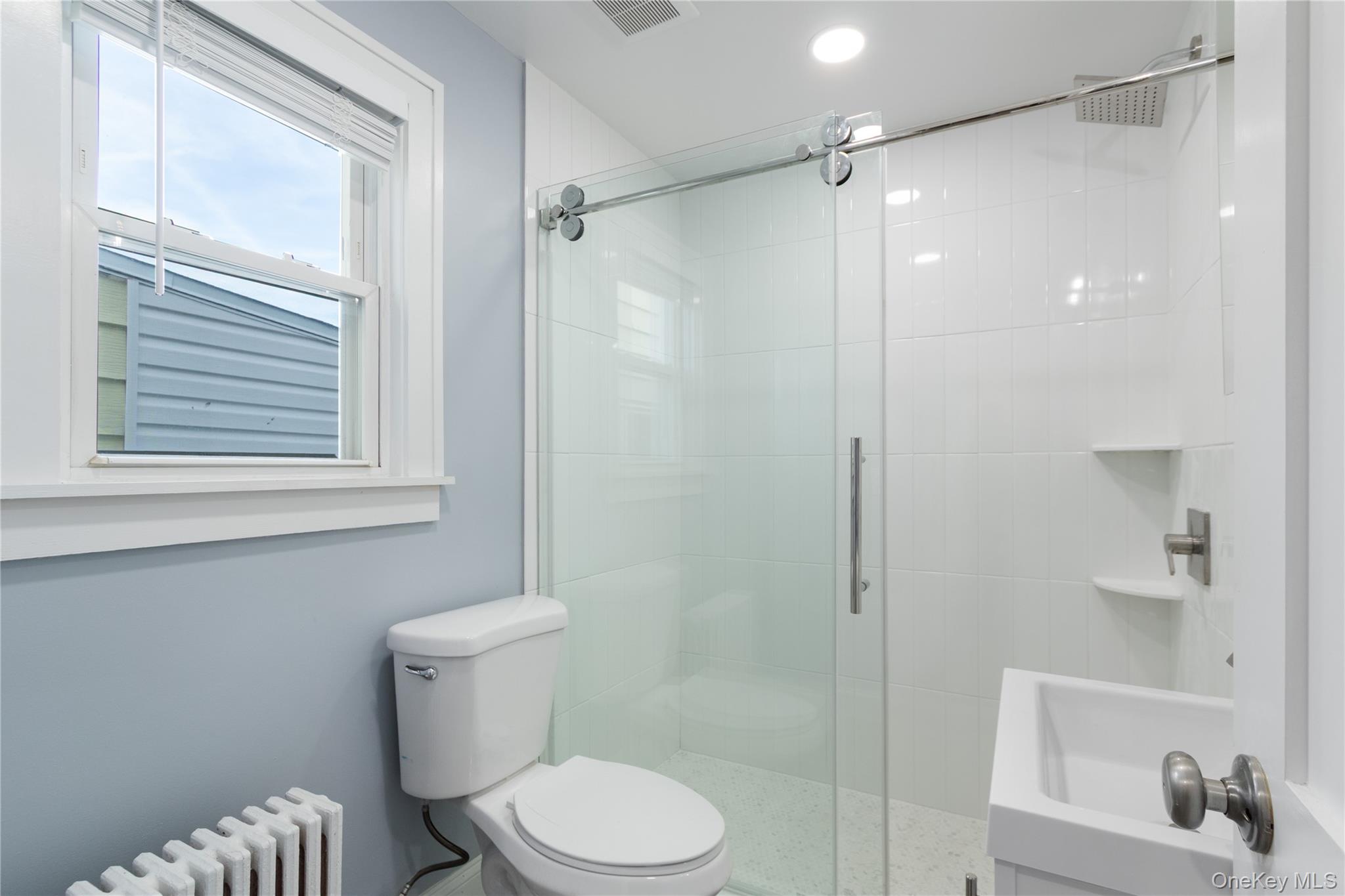 57 Spring Street, Unit 1 Oyster Bay, NY 11771 - Photo 7 of 11 a bathroom with a shower a toilet and a sink