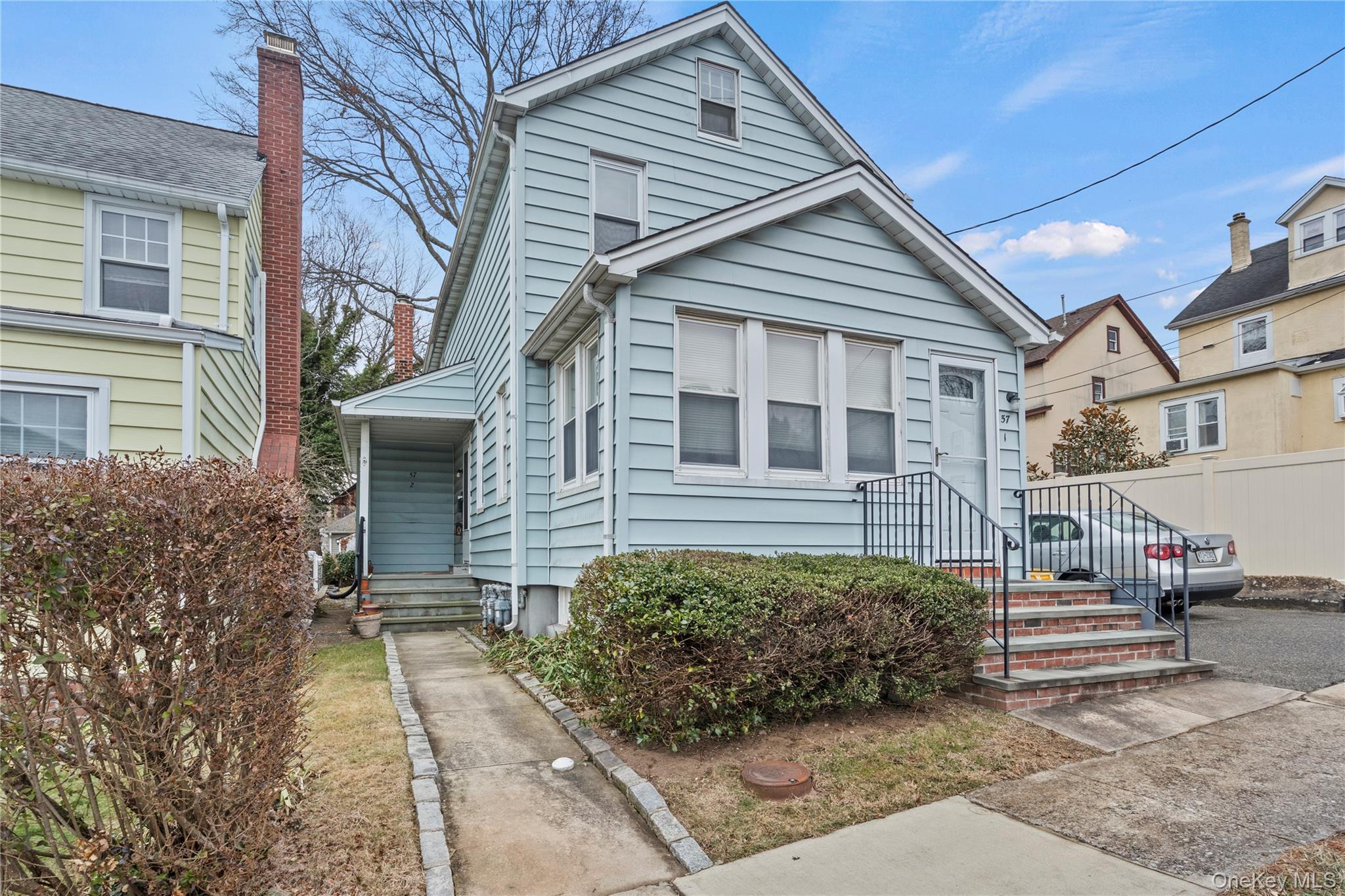 57 Spring Street, Unit 1 Oyster Bay, NY 11771 - Photo 9 of 11 a view of a house with a patio