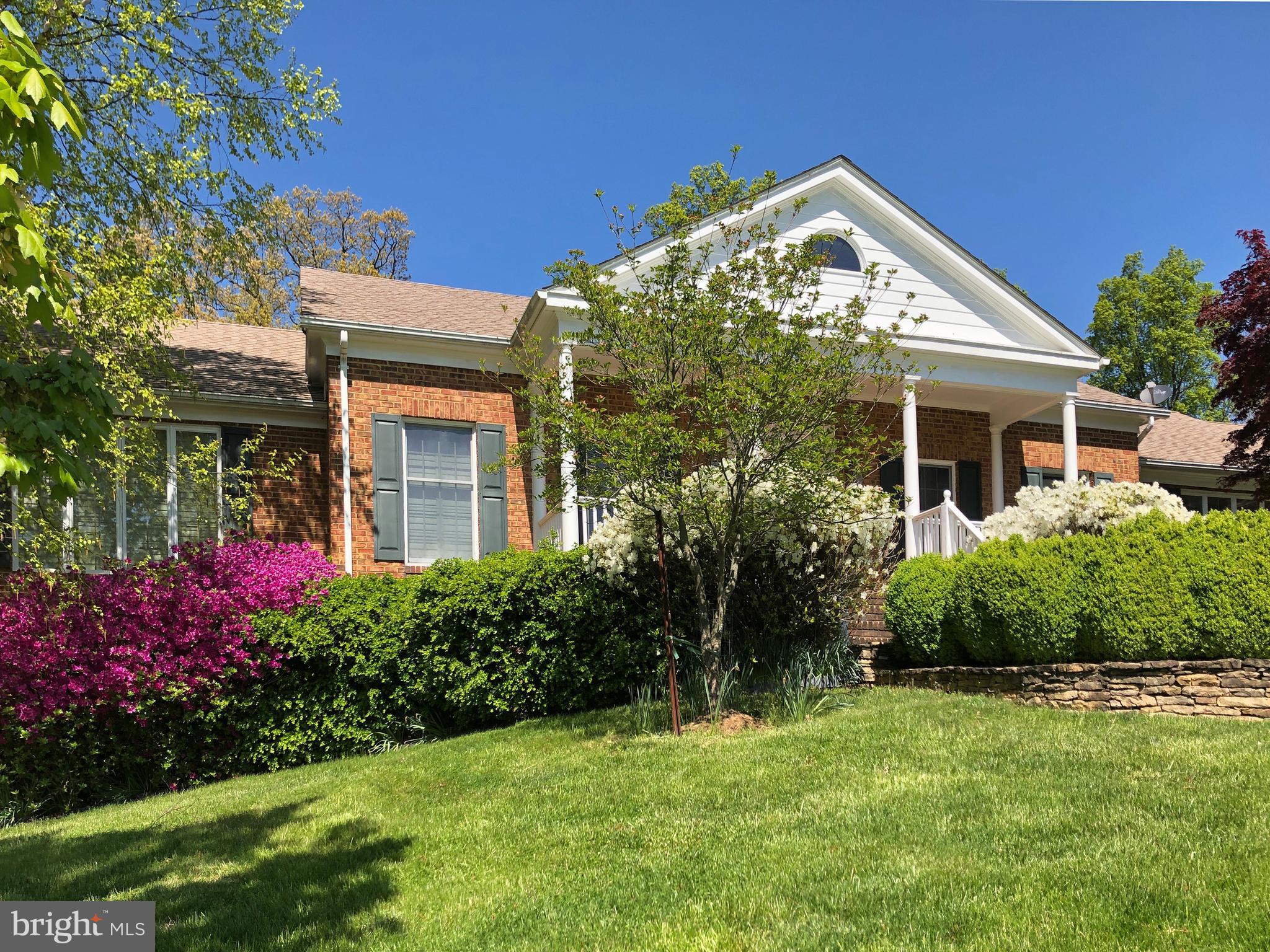 1310 Delaplane Grade Road Upperville, VA 20184 - Photo 53 of 94 View of the house w/flowers blooming in springtime
